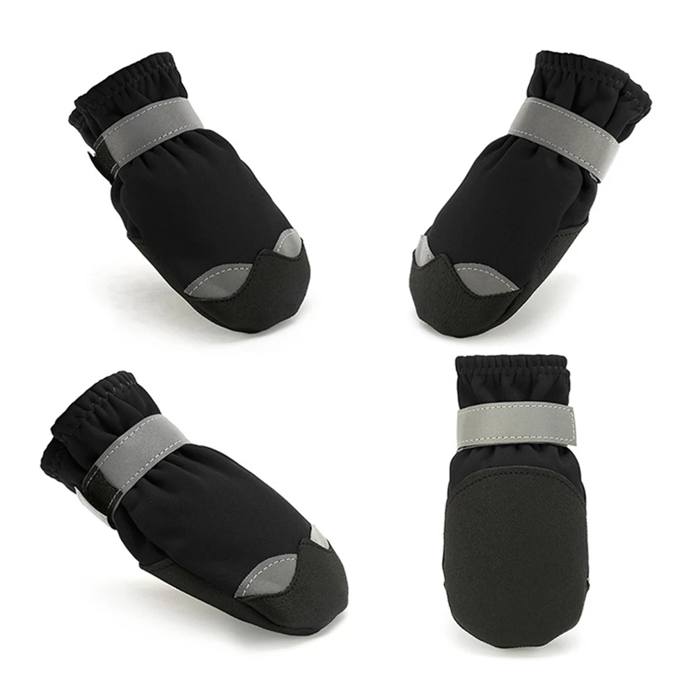 Set of four black dog paw protectors with gray reflective straps arranged on a white background.