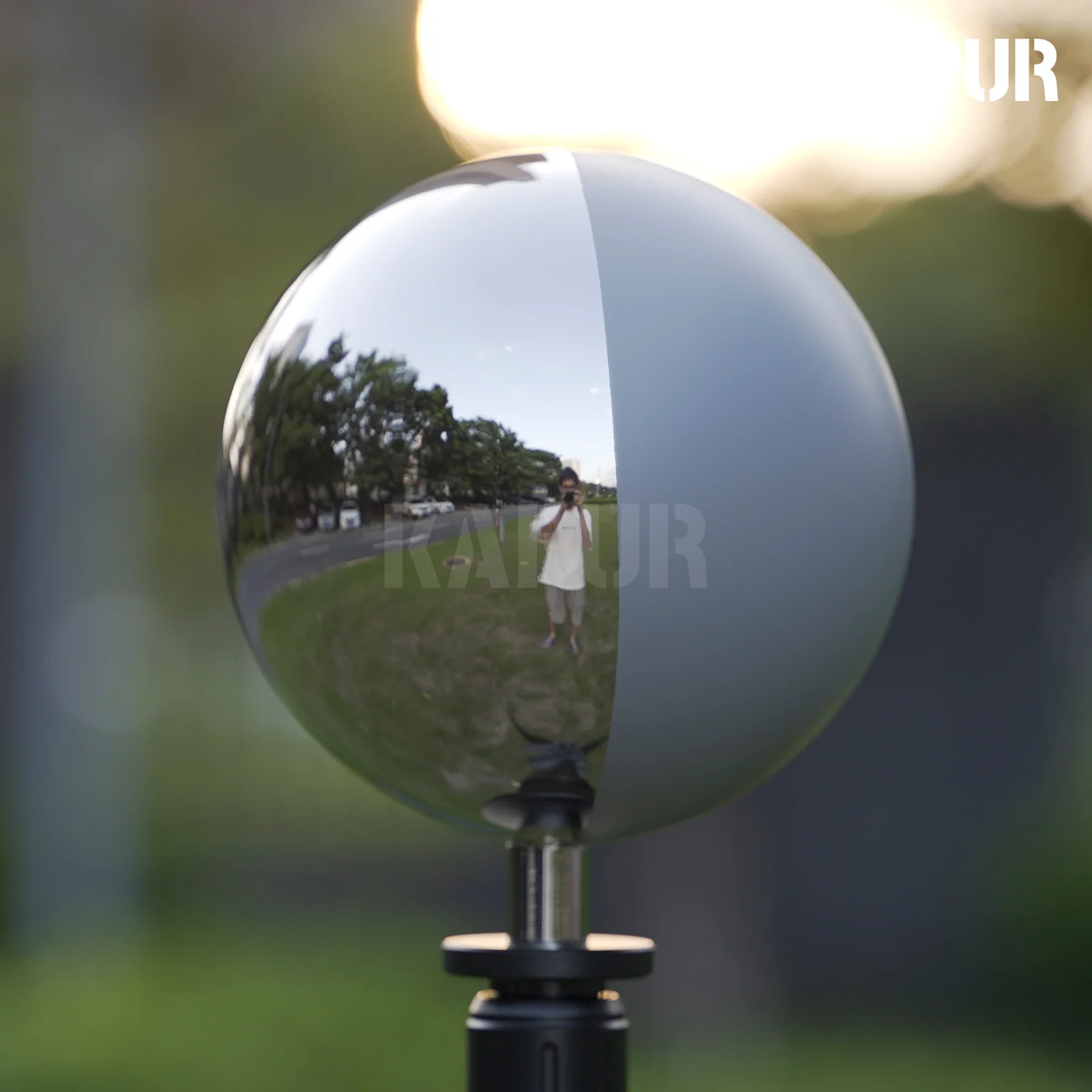 126mm diameter 18% grey mirror ball on a tripod stand, showing reflective surface under studio lighting