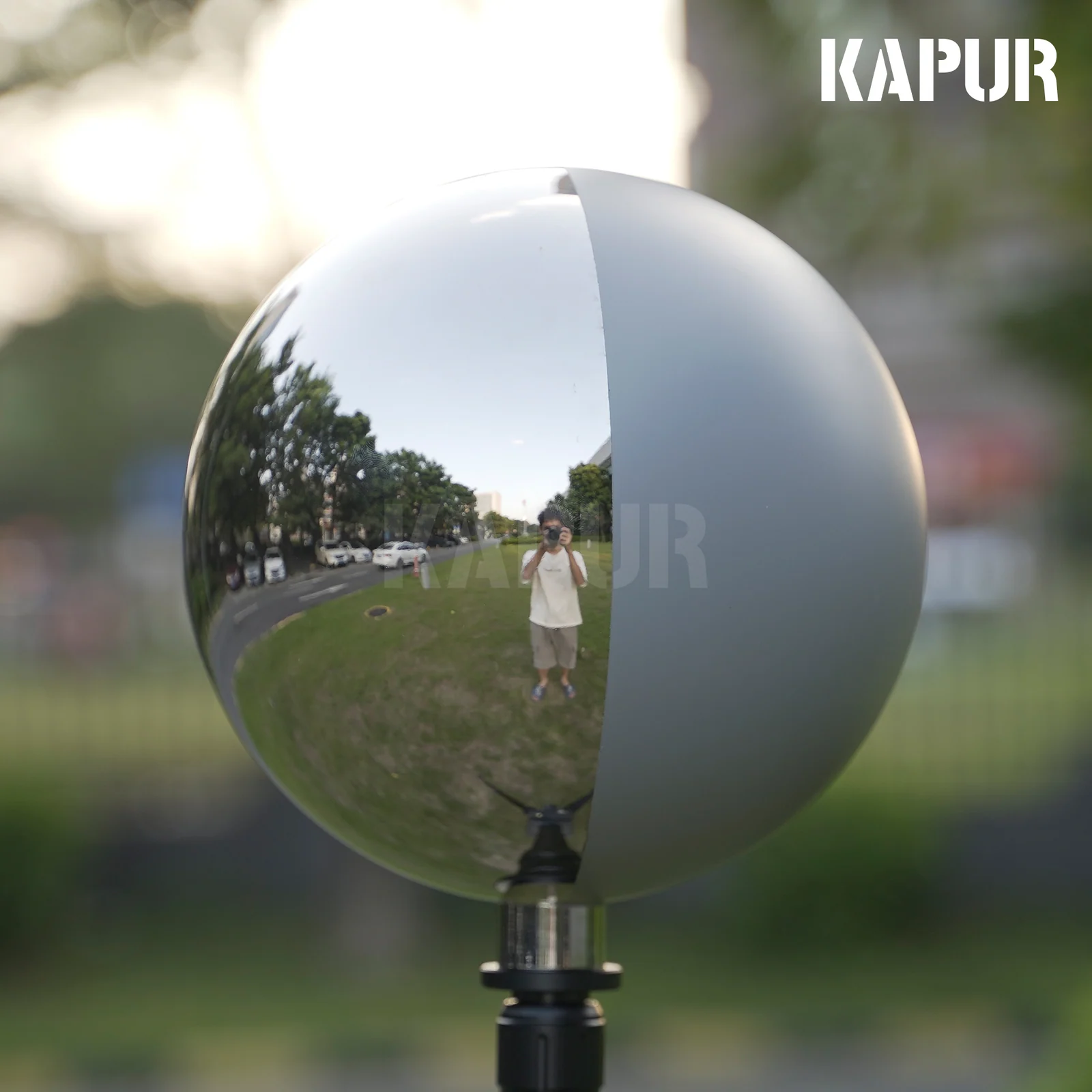 200mm diameter 18% grey mirror ball mounted on a tripod in a studio setting, reflecting a neutral background