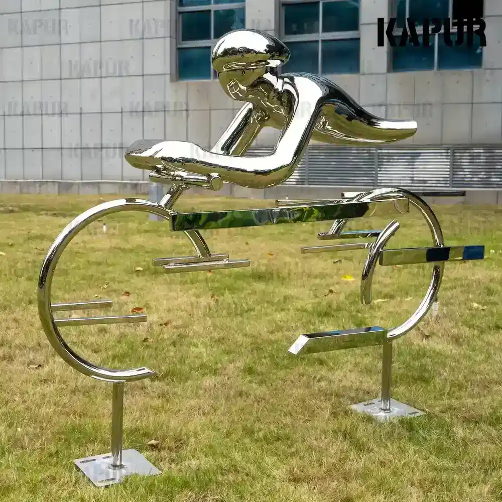 Second view of the abstract stainless steel cyclist sculpture showing the curved form and seamless welds