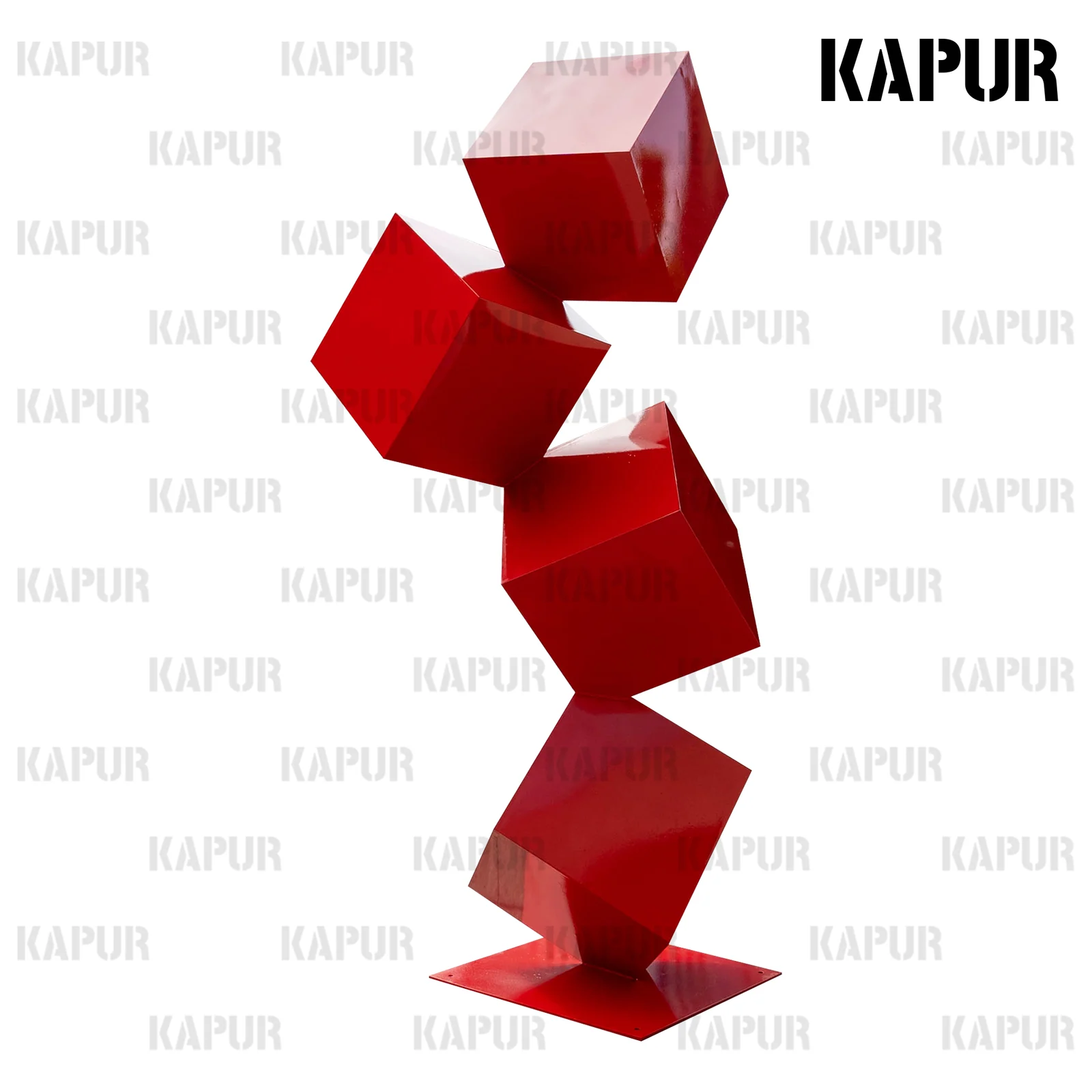 Polished stainless steel cube sculpture standing on a paved outdoor plaza with reflective surface