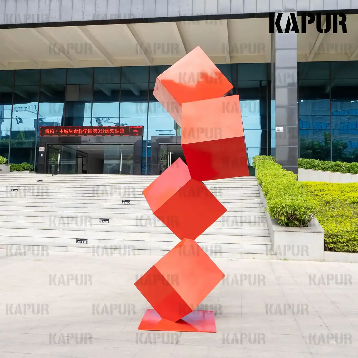 Second view of the stainless steel cube sculpture showing the seamless polished faces and clean geometric form