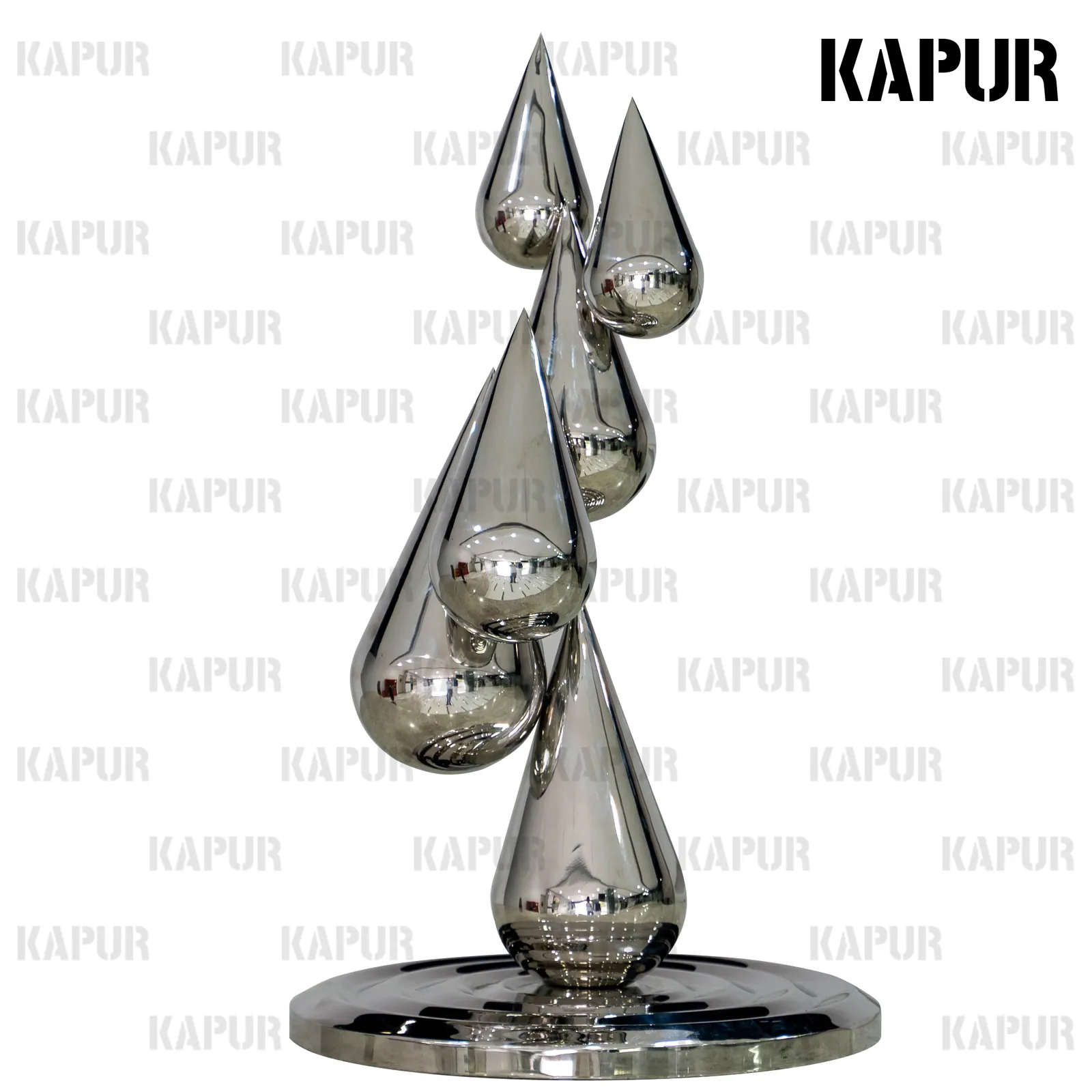 Polished stainless steel water drop sculpture standing on a paved outdoor plaza with reflective surface catching sunlight