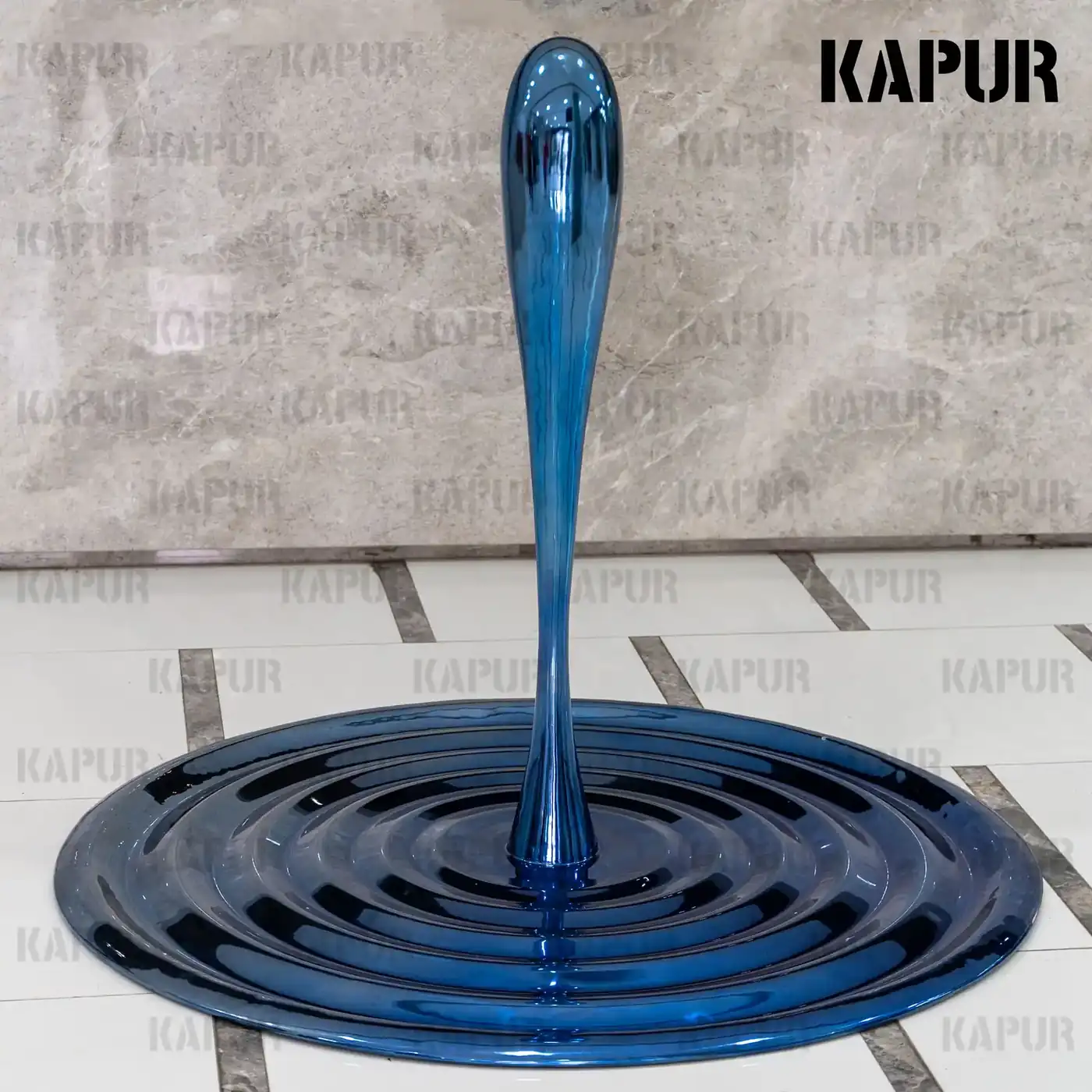 Second view of the water drop sculpture showing the curved reflective surface and seamless welds