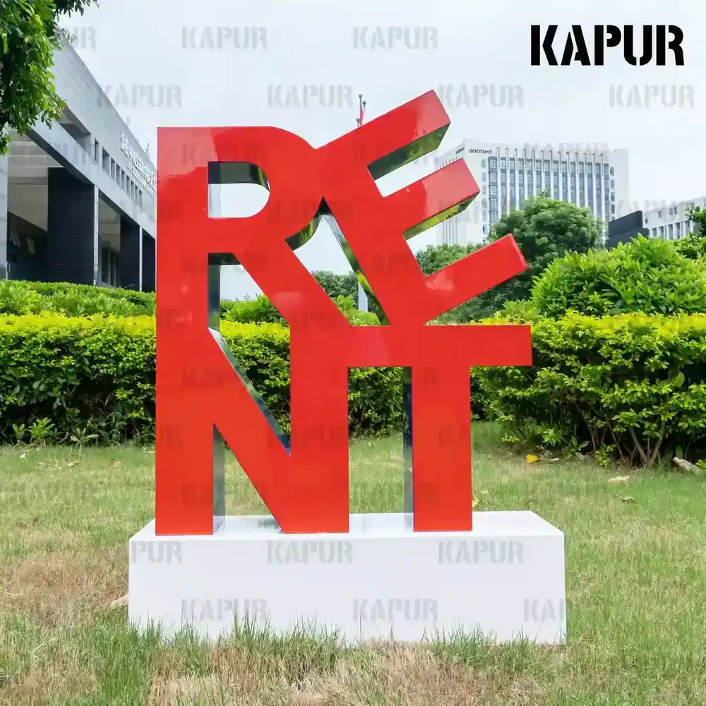 Second view of the stainless steel letter sculpture showing the curved reflective surface and seamless welds