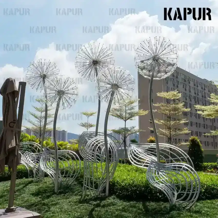 Second view of the dandelion metal art sculpture showing the curved reflective surface and detailed welds