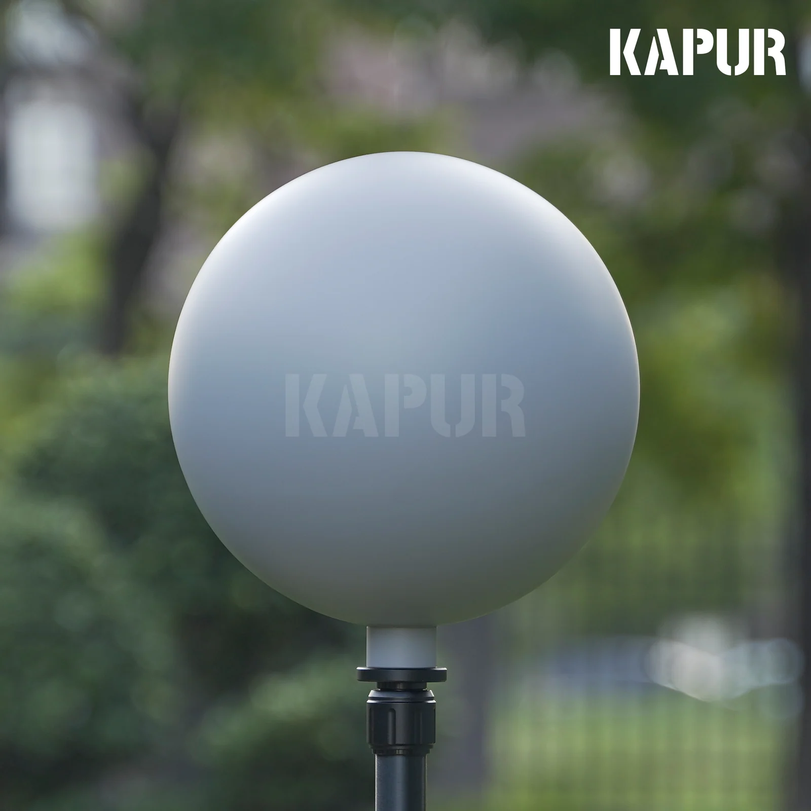200mm diameter 18% gray visual effects ball on a tripod in a studio setting, reflecting a neutral background