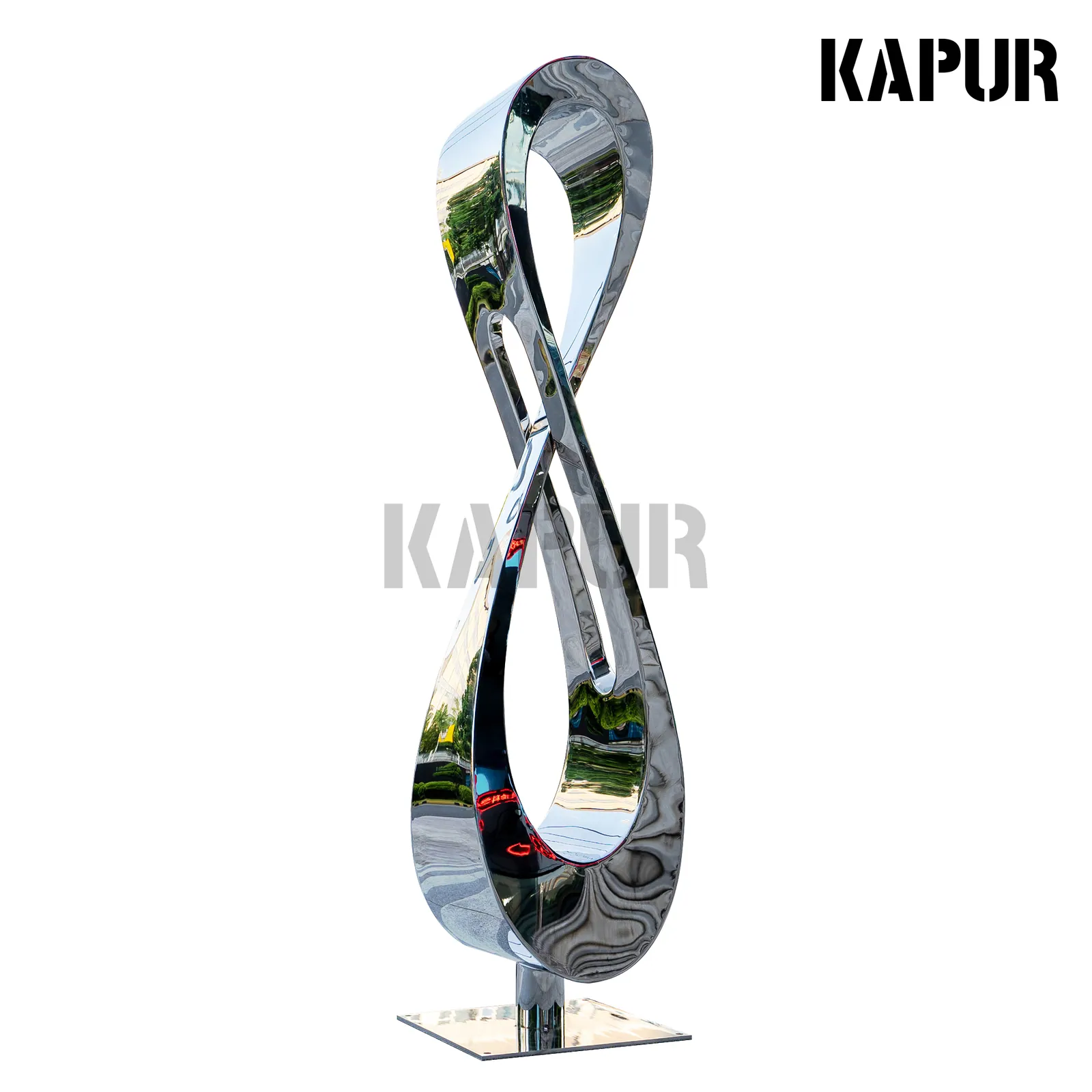 Large polished stainless steel sculpture in modern art style standing in an outdoor garden setting