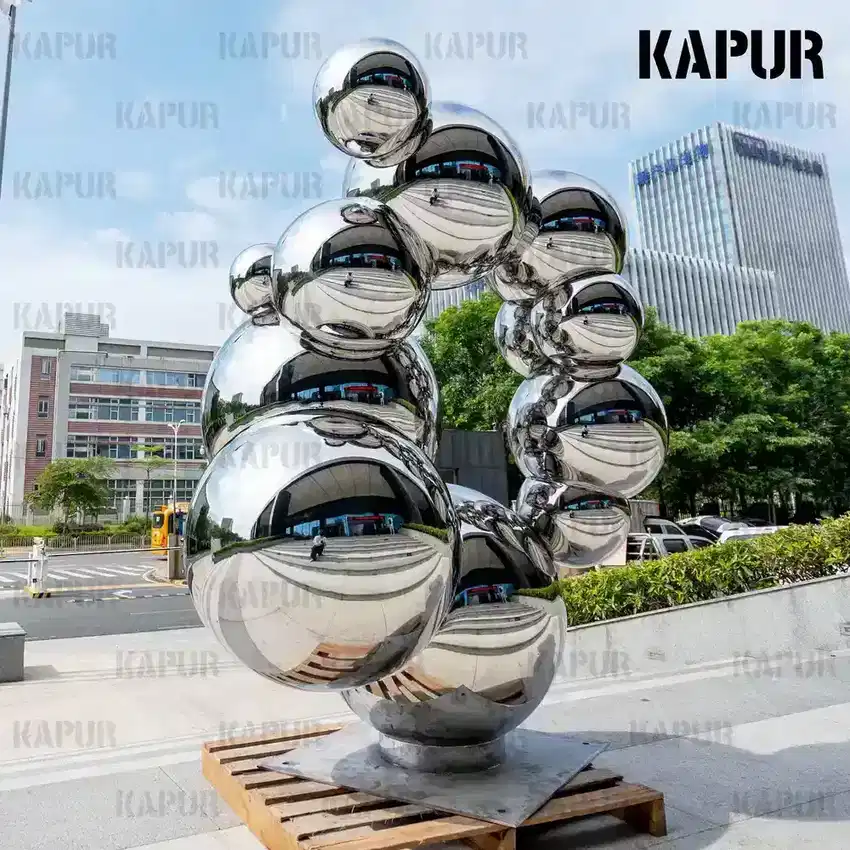 Second view of the stainless steel sphere showing the seamless reflective surface and curved form from a side angle