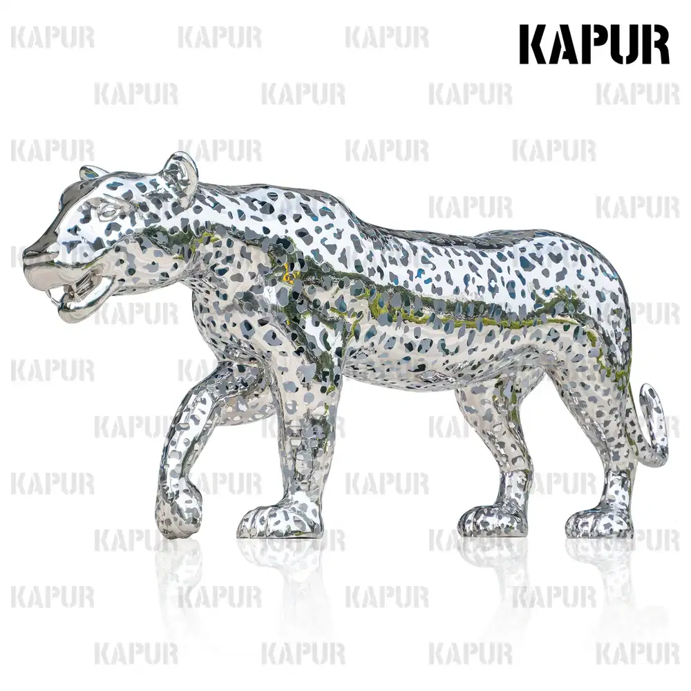 Large hollow leopard animal sculpture in polished stainless steel standing in an outdoor garden setting