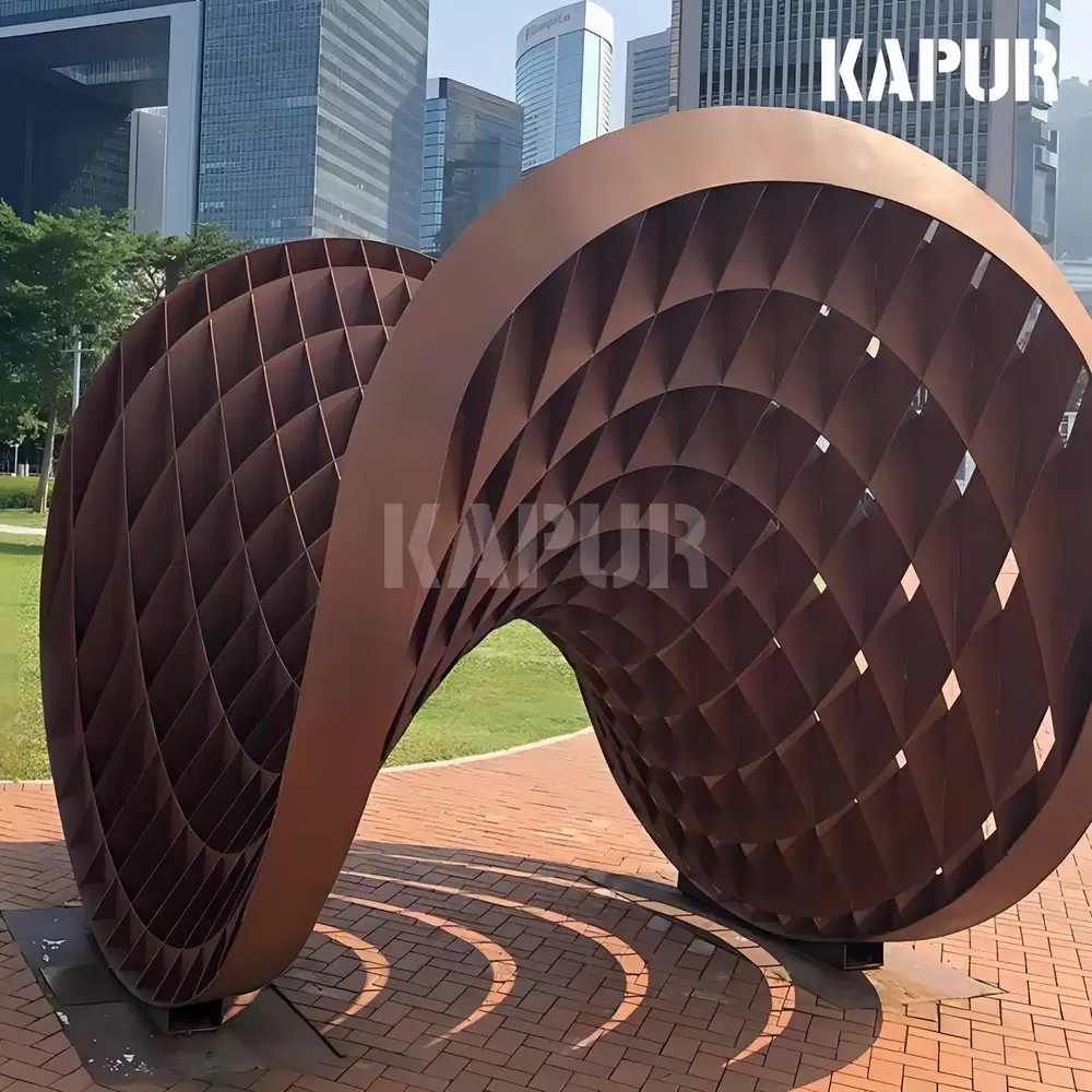 Large corten steel sculpture with natural rust patina standing in an outdoor garden setting