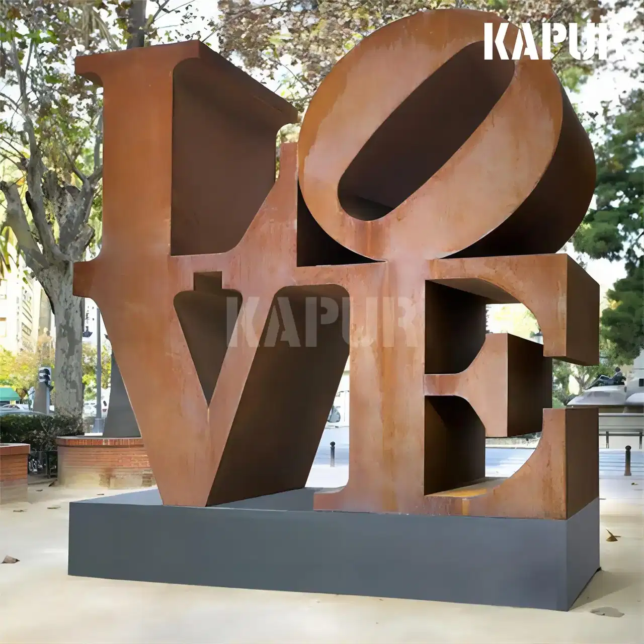 Corten steel 'LOVE' sculpture standing in an outdoor garden with natural rust patina and weathered surface