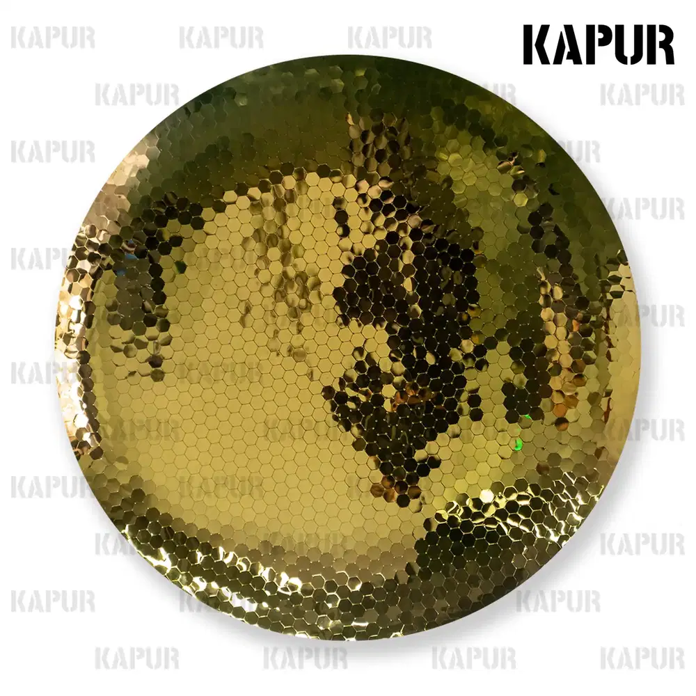 Mirror-polished round hexagonal stainless steel wall decoration mounted on a white interior wall