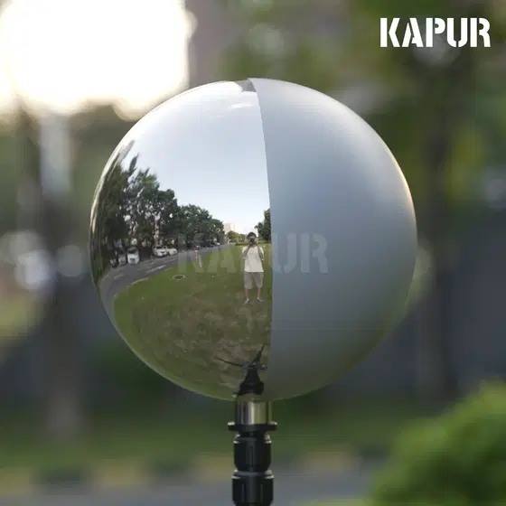 250mm diameter 18% grey visual effects ball on a tripod, reflecting a studio environment with accurate light data