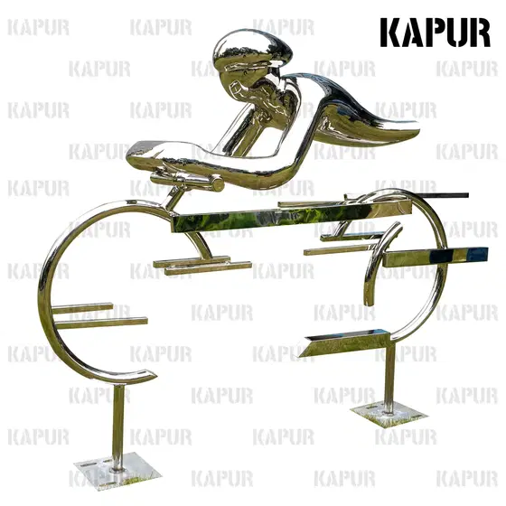 Abstract stainless steel cyclist sculpture standing on a paved outdoor plaza with reflective polished surface