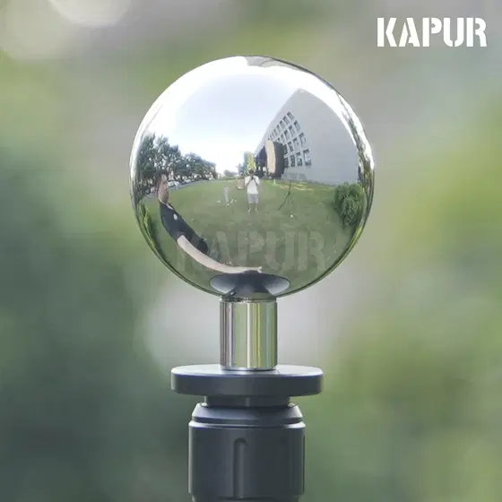 Polished 60mm reflective ball on a tripod base, showing high specular reflection under studio lighting