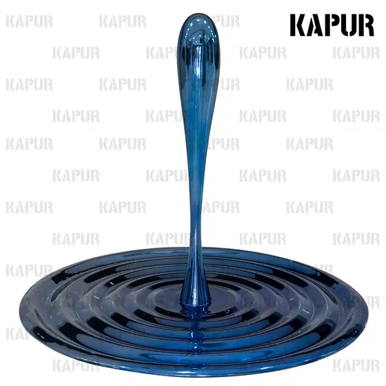 Polished stainless steel water drop sculpture standing on a paved outdoor plaza