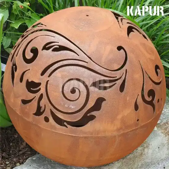 Laser-cut corten steel baroque pattern ball sculpture standing in a garden setting, showing the textured rusted surface and intricate design
