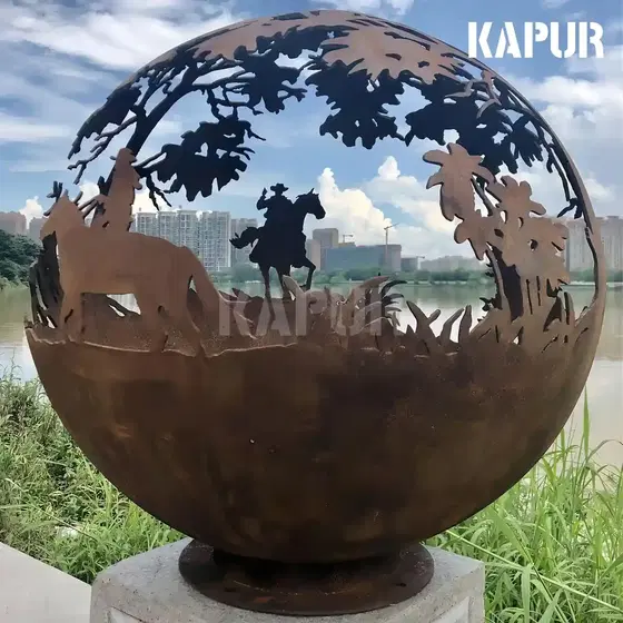 Laser-cut corten steel round ball sculpture standing in a garden with plants around it, showing the natural rust patina