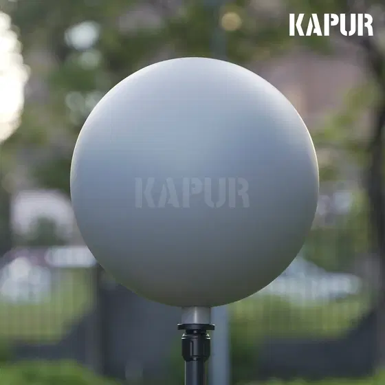 250mm diameter 18% gray visual effects ball on a tripod in a studio setting, reflecting light evenly