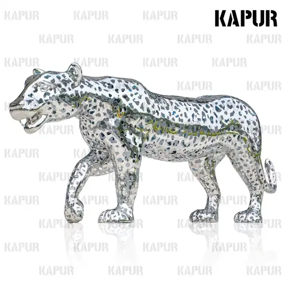Large hollow leopard animal sculpture in polished stainless steel standing in an outdoor garden setting