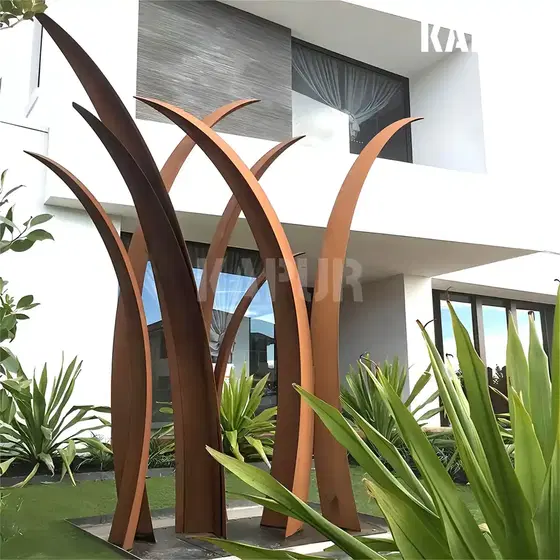 Corten steel sculpture shaped like swaying grass standing in an outdoor garden, showing natural rust patina and organic form
