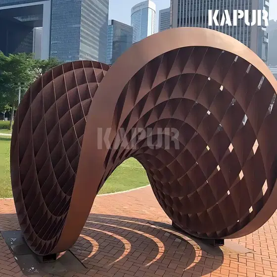 Large corten steel sculpture with natural rust patina standing in an outdoor garden setting