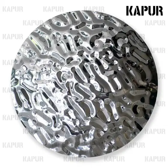 Round stainless steel water ripple wall decoration with mirror finish mounted on a white interior wall