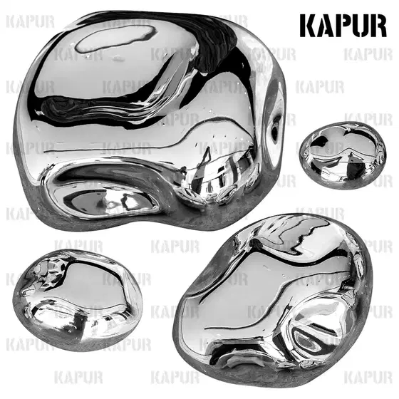 Stainless steel irregular pebble wall decoration mounted on a modern interior wall with reflective surface