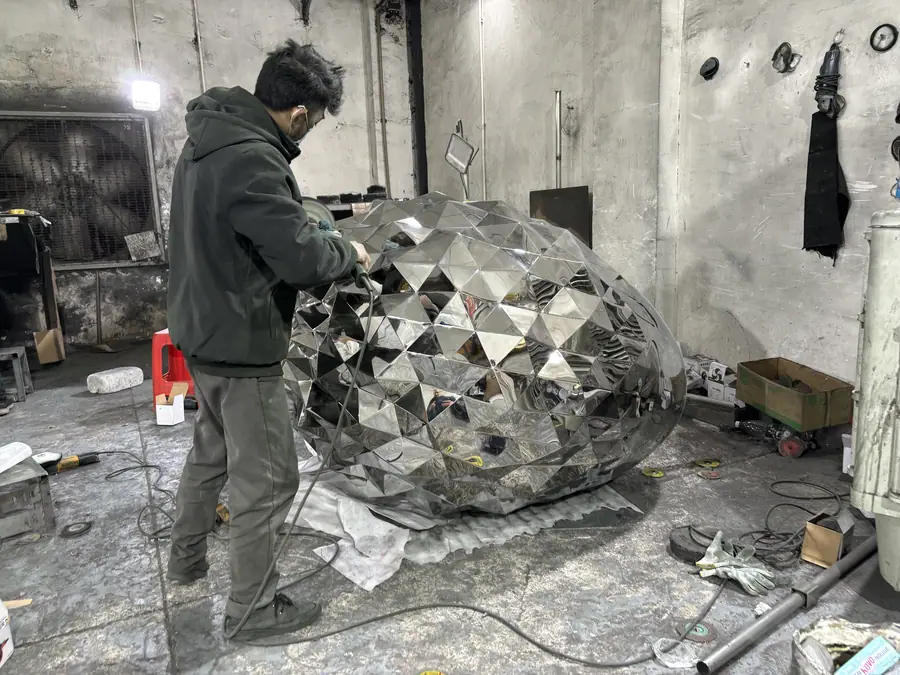 Stainless steel pine cone sculpture