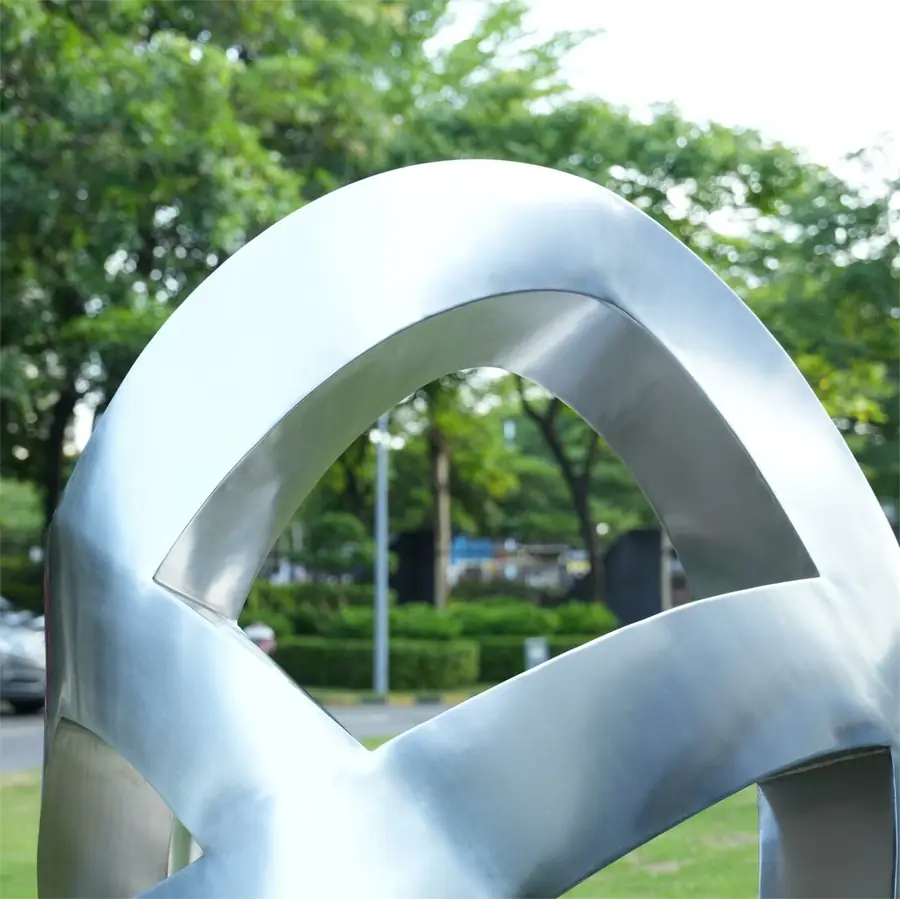 Stainless steel abstract ribbon-wrapped sculpture