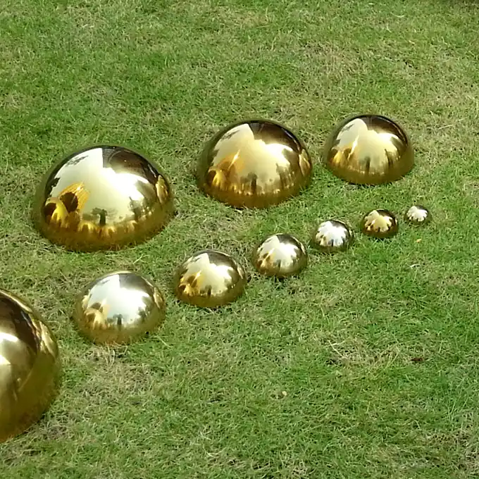 Analyze the production process and challenges of stainless steel sphere sculptures