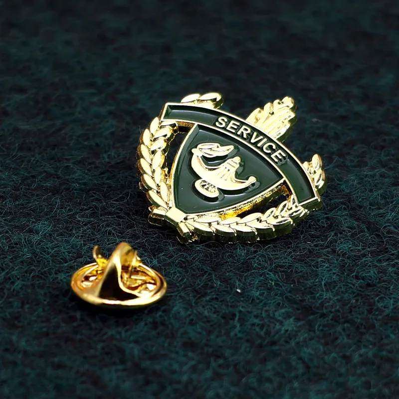 Close-up of a custom 3D edge gold lapel pin showing the textured gold plating and enamel detail