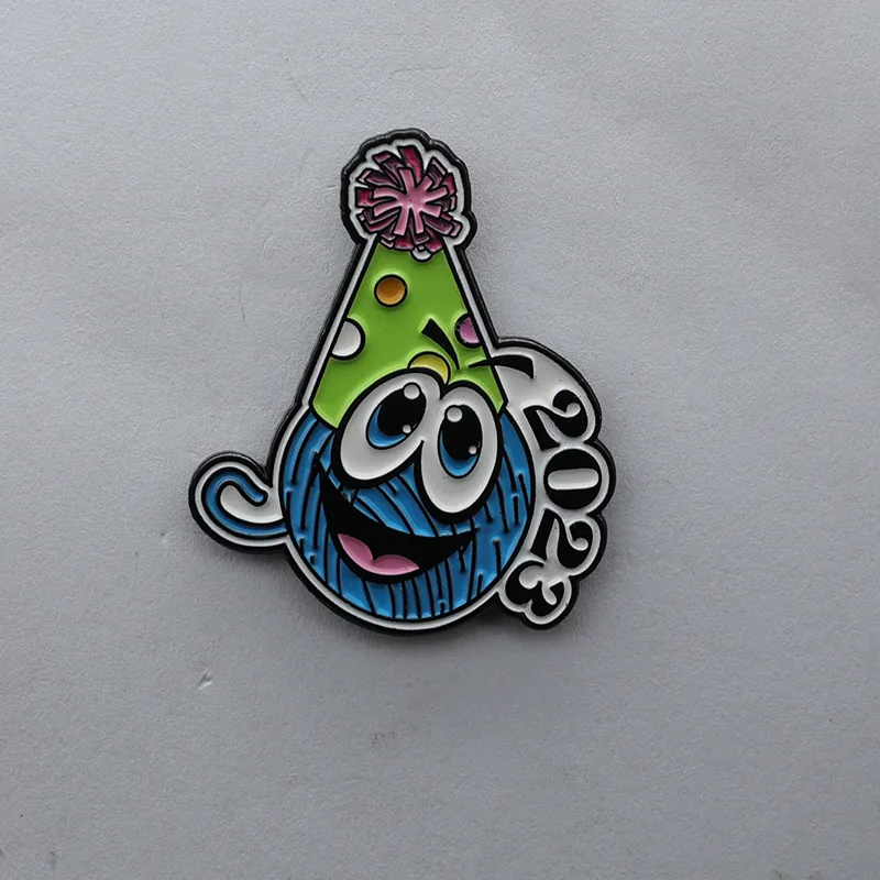 Black background enamel lapel pin with a cute cartoon avatar design in bright colours, showing detailed facial features and playful style