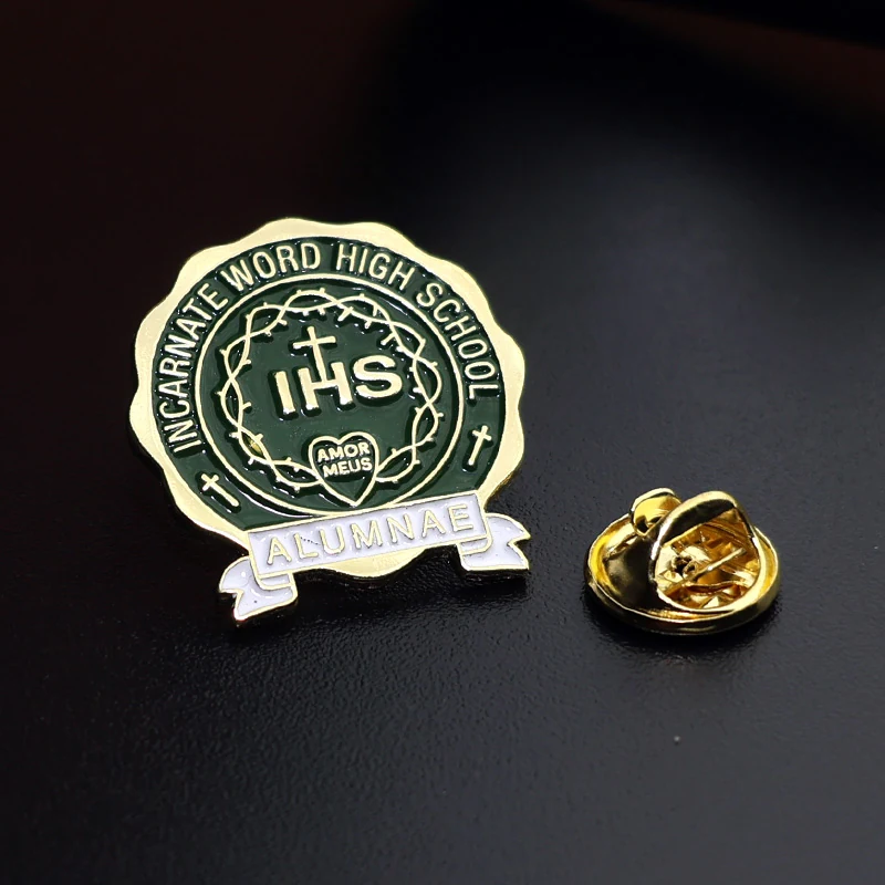 Side view of a 25mm green lapel pin with the safety pin back attached