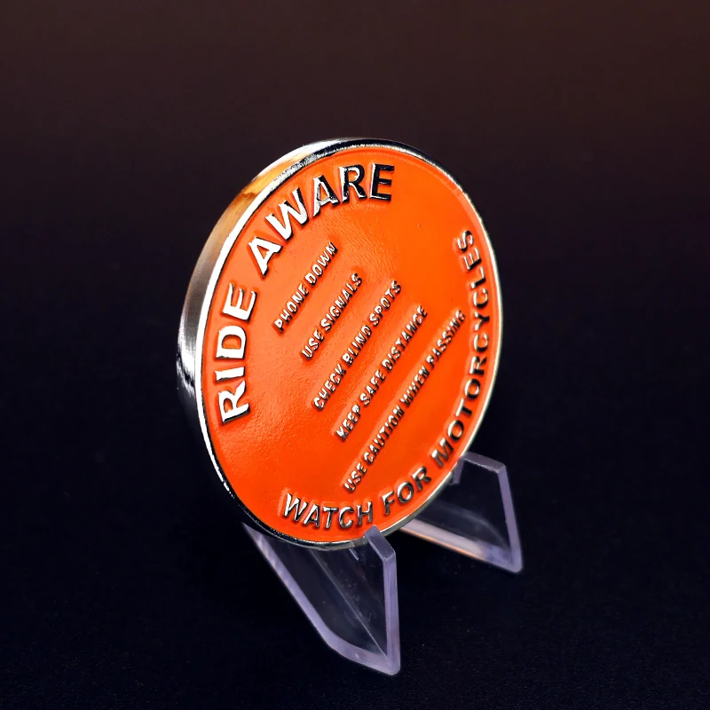 Side view of a custom challenge coin showing beveled edge and pin back