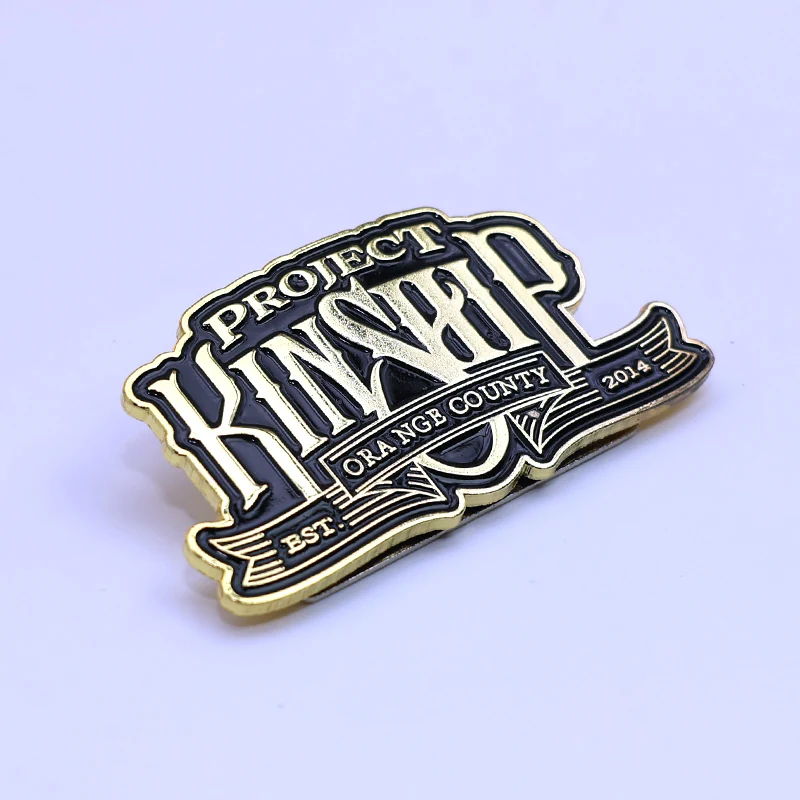 Custom antique brass lapel pin with no enamel, showing detailed die struck design and weathered finish