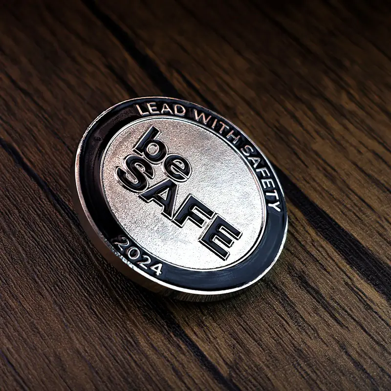 Side view of a custom challenge coin showing the raised relief and enamel fill