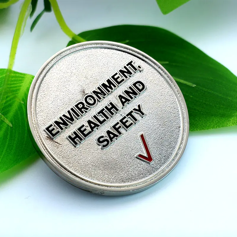 Group of custom challenge coins with different safety messages and finishes