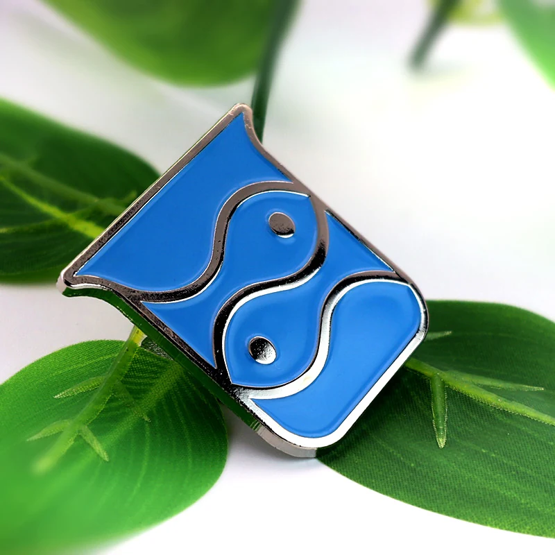 Side view of the blue fish lapel pin showing the raised enamel and metal edges