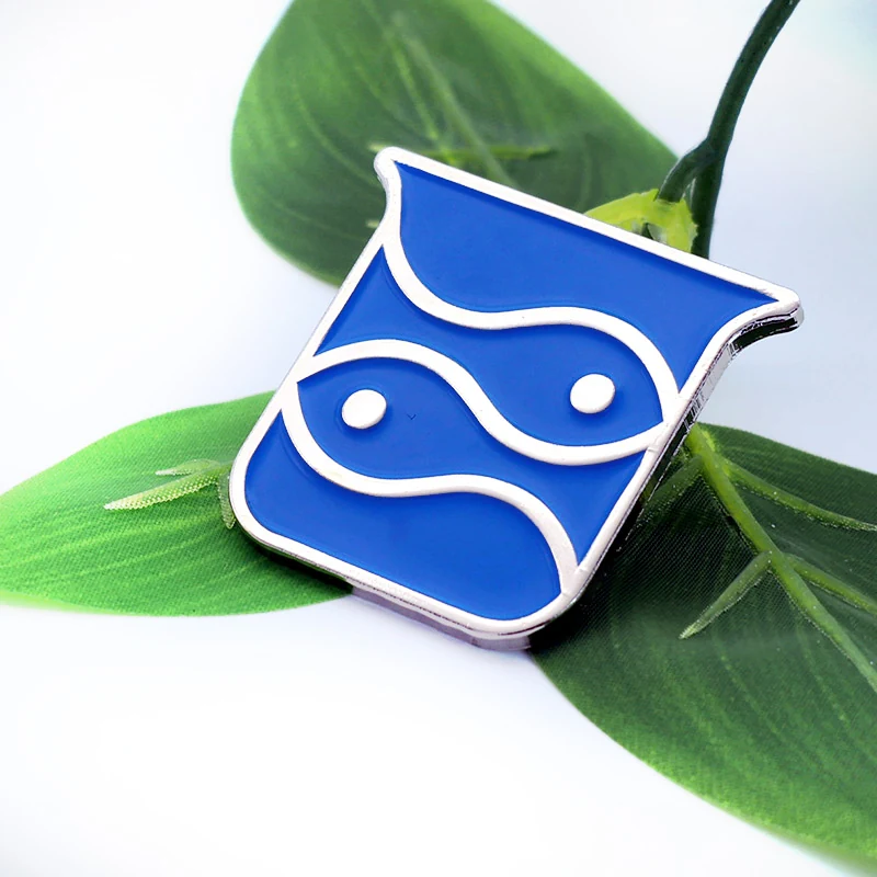 Close-up of the fish design and pin back on a custom blue sea creature lapel pin