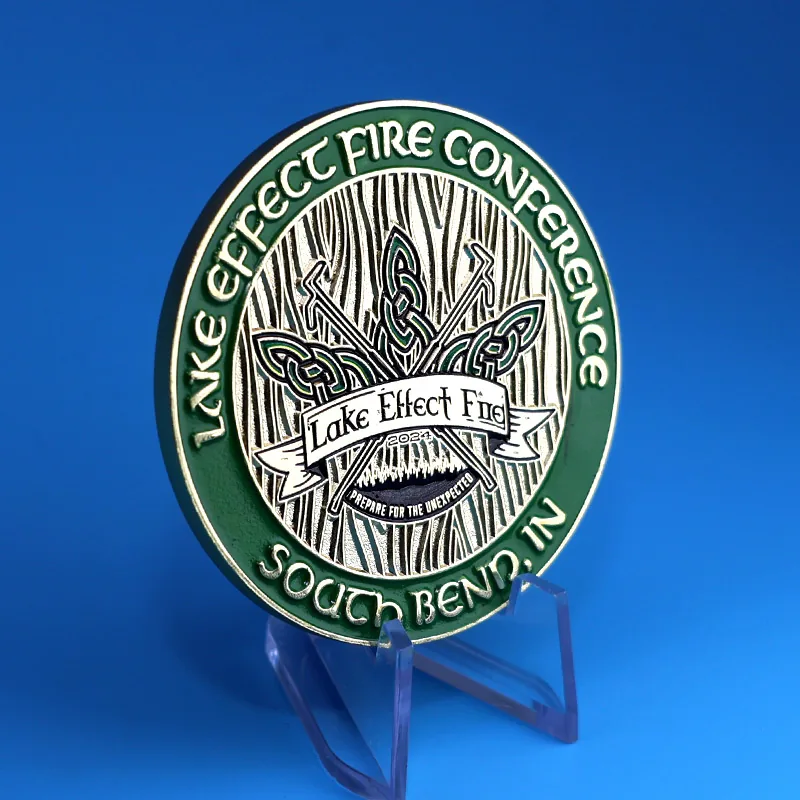 Side view of a custom challenge coin showing the split ring attachment and epoxy dome