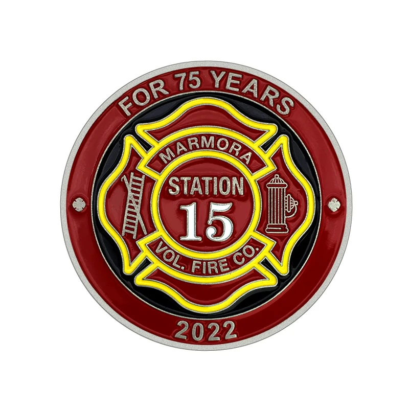 Reverse side of a custom fire logo challenge coin with engraved text and metal pin