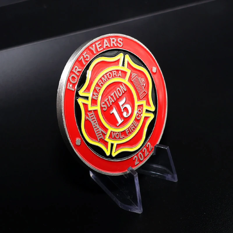 Detail of the die struck fire truck silhouette and enamel fill on a custom challenge coin