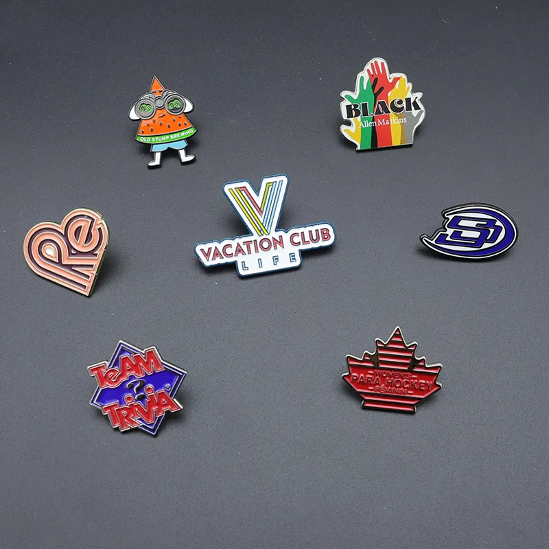 Set of hand-shaped heart pins in different finishes including gold silver and antique