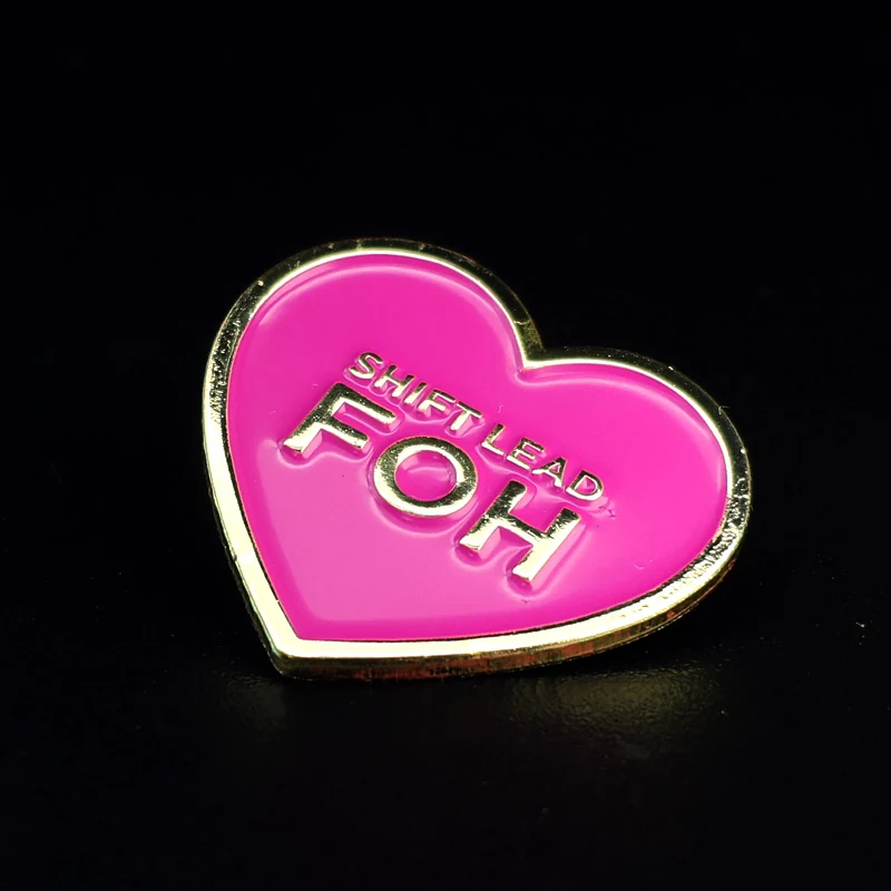 Side view of a heart-shaped enamel pin with swivel clasp attachment