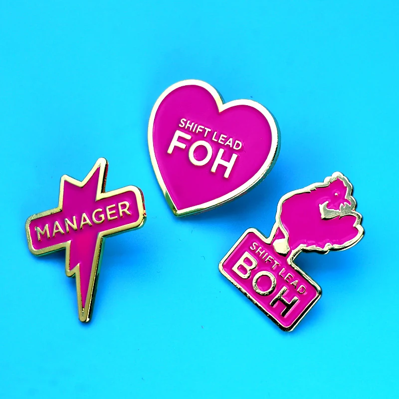 Set of three heart-shaped enamel pins in different colours and finishes