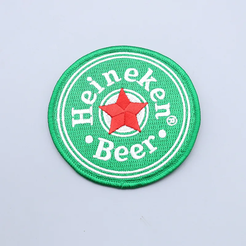 Custom round star-shaped beer patch with embroidered design and text on a dark fabric background