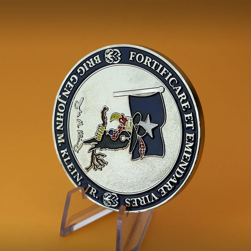 Reverse side of a custom Navy challenge coin with unit insignia and engraved text