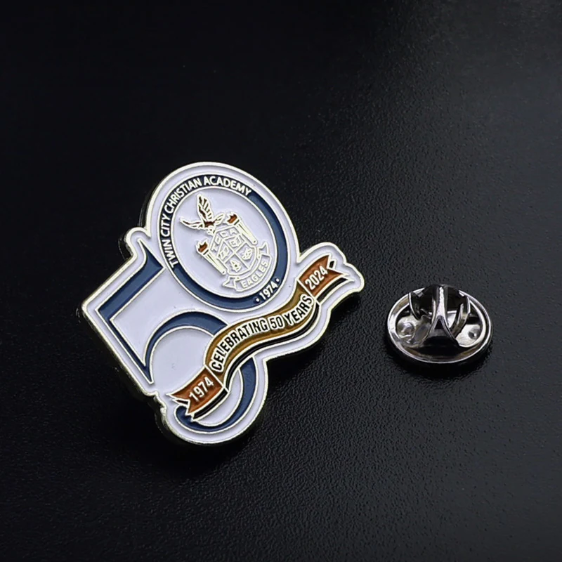 Lapel pin worn on a jacket lapel with a 50th anniversary theme and polished gold finish